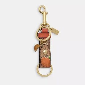 Coach | Trigger Snap Bag Charm in Signature Canvas With Orange Print